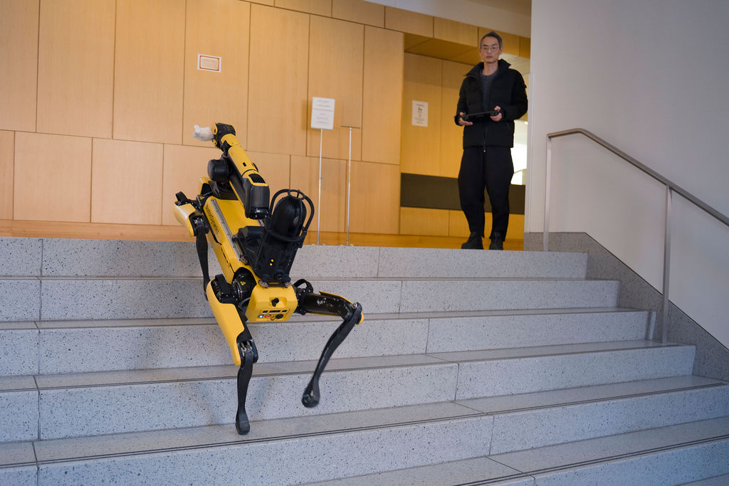 Anthropology Professor Ryo Morimoto demonstrates Spot's agility on the stairs. Photo by Jodi Hilton/Harvard Faculty of Arts and Sciences